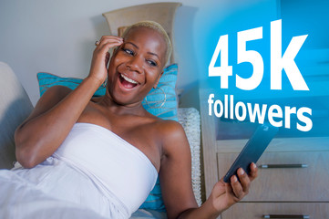 young cool and happy black African American woman relaxed at home using internet mobile phone...