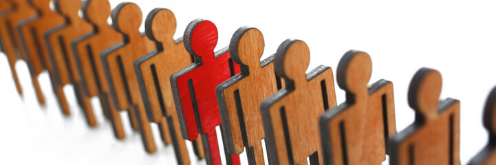 Male red plastic toy businessman silhouette wooden figure background closeup. Manipulate work...
