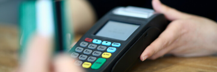 Customer paying with credit card via payment terminal at cash desk background concept - obrazy, fototapety, plakaty