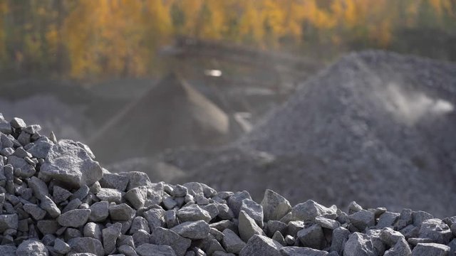 Industrial background - crusher stone crushing machine at the quarry of a mining and processing plant for crushed stone