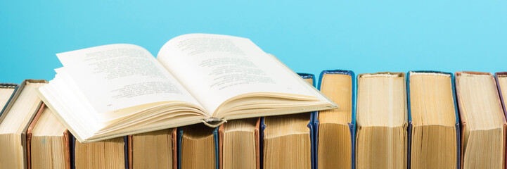 Fototapeta premium Open book, hardback books on wooden table. Back to school. Copy space
