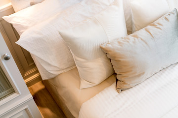 Bed maid-up with clean white pillows and bed sheets in beauty bedroom. Close-up. interior background