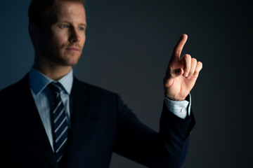 smart caucasian businessman formal suit portrait half body hand point copy space with dark color background