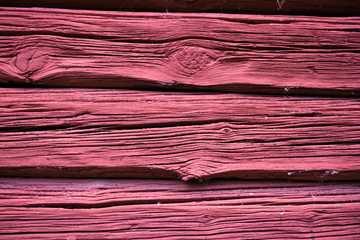 Old red planks on a Swedish barn close up for background
