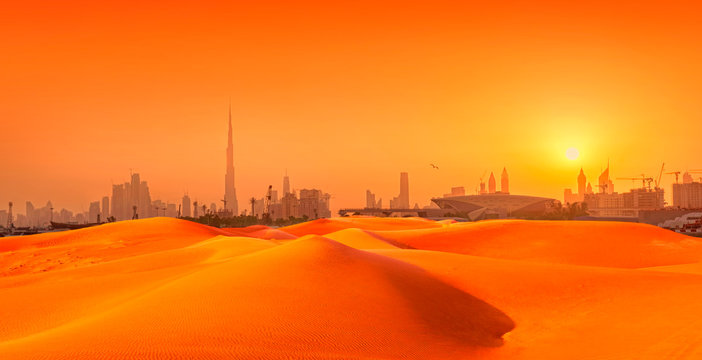 Dubai cityscape panorama with sand dunes at sunset. composite image of city and sand