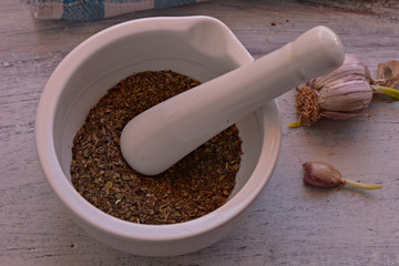 Pepper in white mortar and garlic at old wooden rustic background/ food background