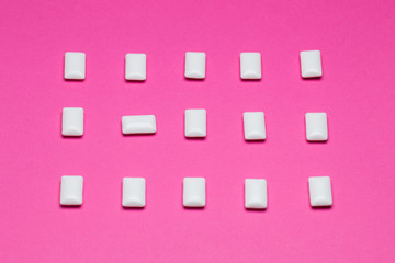 Chewing gum close up on a pink background