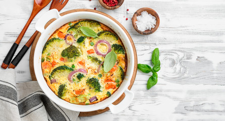 Frittata or casserole with broccoli and vegetables in baking dish. Vegetarian recipe.