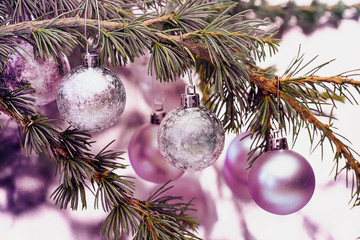 pink Christmas baubles hanging on tree