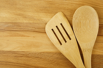 Spatula and spoon on wooden table background, cooking concept