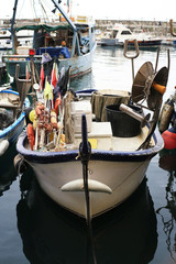 Fototapeta na wymiar Old fishing boat with tackle in Italy