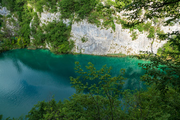 Karst rock face and azure colored lake at the Plitvice Lakes National Park in Croatia