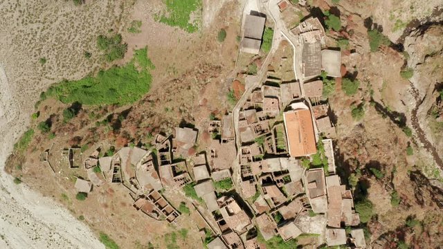 Roghudi Vecchio fascinating Italian ghost town located in Aspromonte mountains in Southern Italy. It was abandoned in 1973 after a series of natural disasters (flood). Travel destination. Aerial Shot.