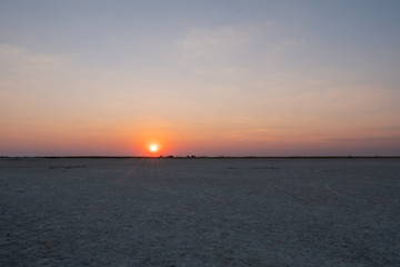 Sun Setting in Makgadikgadi Salt Pan - Empty Flat Plain and Horizon © Dietmar