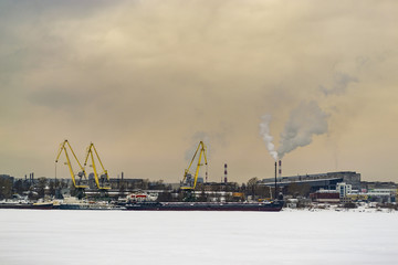Fototapeta na wymiar Winter industrial landscape with cranes and ships