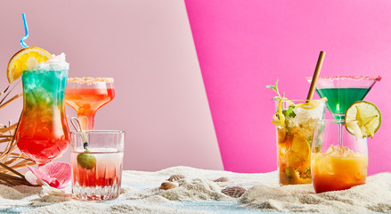 Assorted tropical cocktails on two tone pink