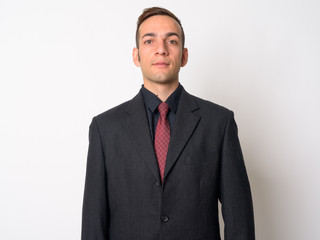 Young Persian businessman in suit looking at camera