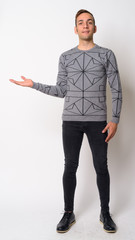 Full body shot of happy young Persian man showing something