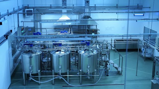 Industrial production of milk. Steel new pipelines and vats on milk factory