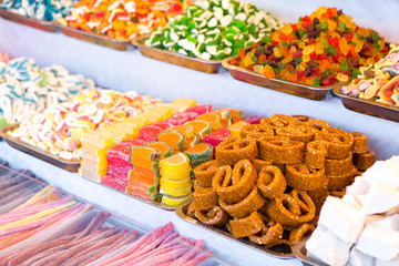 Assorted donuts with chocolate frosted, pink glazed and sprinkles donuts. 
