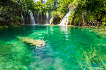 Pure fresh water rushing into an azure coloured lake at the Plitvice Lakes National Park, Plitvička Jezera, Croatia