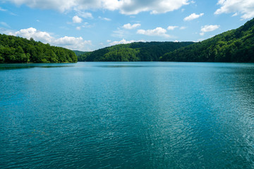 Scenic view of the azure coloured Lake Kozjak surrounded by densely wooded hills at Plitvice Lakes National Park in Croatia