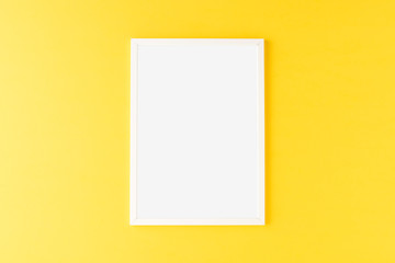 White photo frame with copyspace yellow background