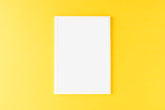 White photo frame with copyspace yellow background