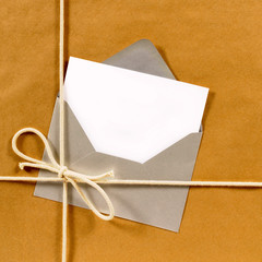 Brown paper parcel with silver envelope