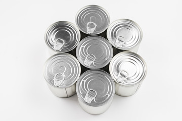 Group of silver canned food on white background.
