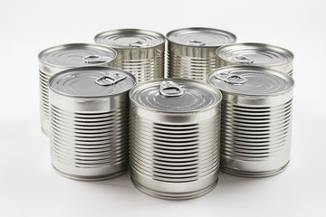 Group of silver canned food on white background.