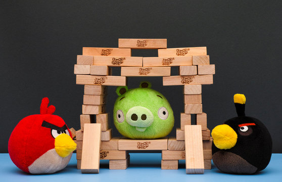 Tambov, Russian Federation - March 03, 2016 Bomb and Red Angry Birds with Bad Piggy in Jenga castle