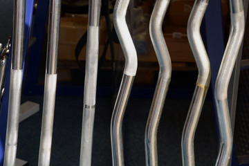 close-up of empty rods without weights, different horizontal rod or lifting bar or grif rod without people body building background