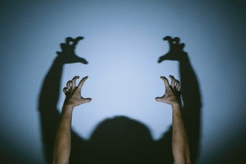 shadow of evil hands on the wall. halloween prank