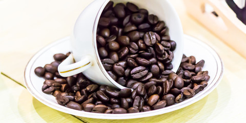 Raw roasted coffee beans in cotton sack.