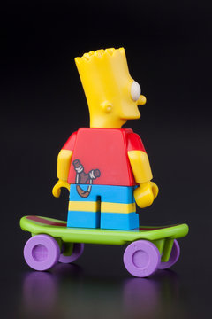 Tambov, Russian Federation - April 30, 2014: Lego Bart Simpson mini figure back view on skateboard on black background. 