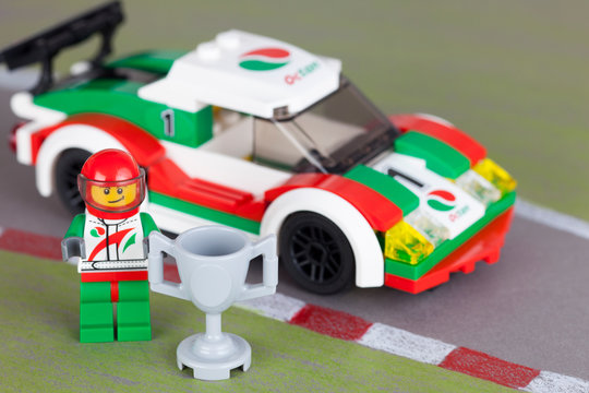Tambov, Russian Federation - March 18, 2014: LEGO City Race Car and pilot with cup on drawing race track. Studio shot.