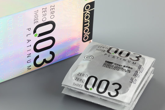 Tambov, Russian Federation - August 29, 2013: Okamoto 003 Platinum condoms with box on gray background. Studio shot.