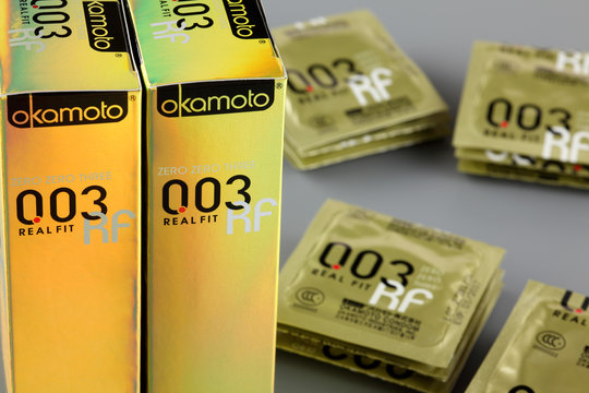 Tambov, Russian Federation - August 29, 2013 Okamoto 003 Real Fit condoms with boxes. Studio shot.