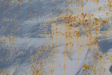 Sloppy gray painted metal surface with rust stains