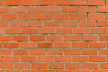 Texture of uneven red ceramic bricks wall