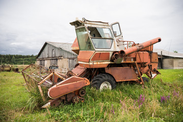 Fototapeta premium Old grain harvester in the field