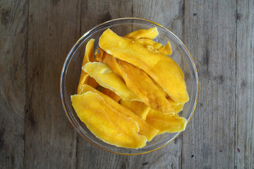 Dehydrated Mango or Dried Mango in glass bowl on wooden table 