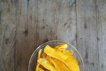 Dehydrated Mango or Dried Mango in glass bowl on wooden table 