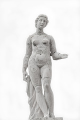 Roof statue of a beautiful Renaissance Era naked woman at Old Library of Saint Marco (Marciana) in Venice isolated at white background, Italy
