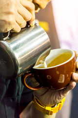Showcase Barista making Latte art coffee and Barista heating milk for making Latte art coffee.