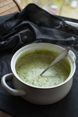 vegan green cream soup in a pan. close-up