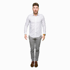 Fototapeta premium Young handsome business man afraid and shocked with surprise expression, fear and excited face.