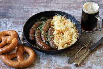 Oktoberfest food. Hot Bavarian sausages with sauerkraut in a pan. Delicious beer festival food
