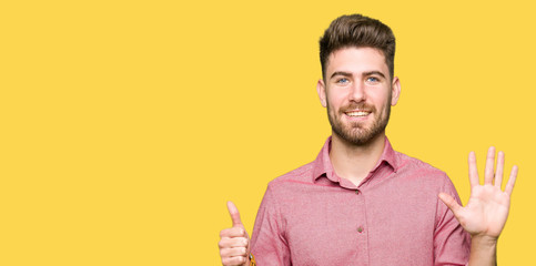 Young handsome business casual man showing and pointing up with fingers number six while smiling confident and happy.